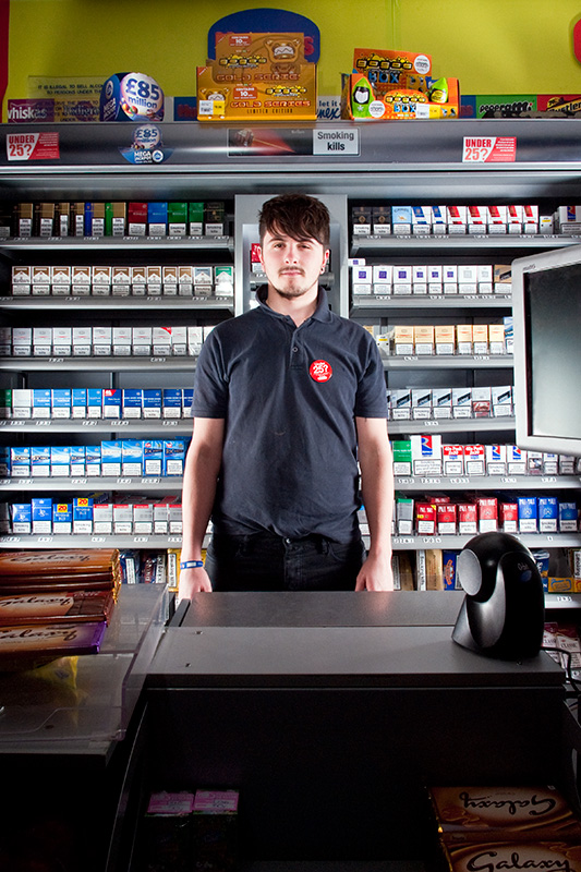 A model behind the counter of a convenience store