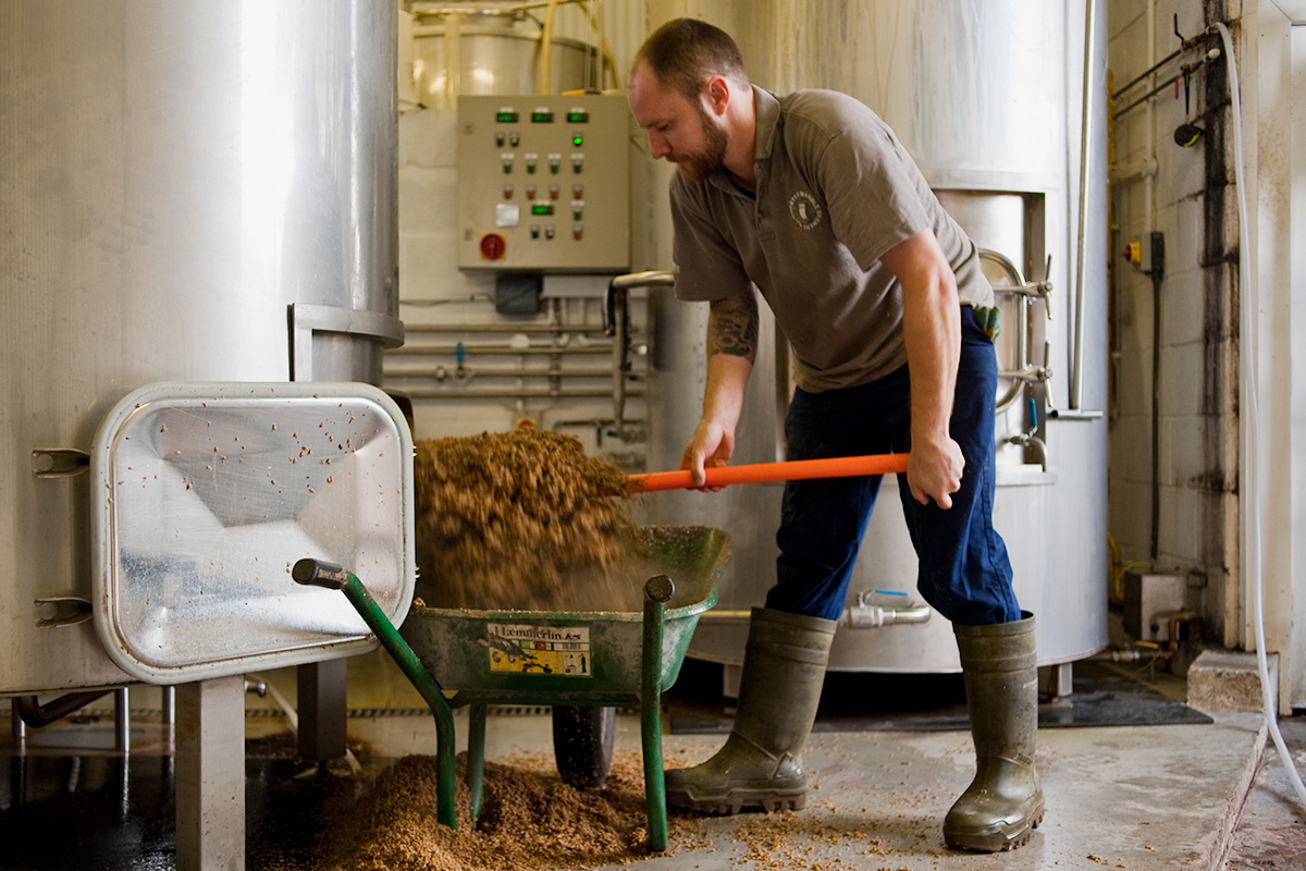 Colin Stronge digging grist from the mash tun at Marble Beer's new brewery
