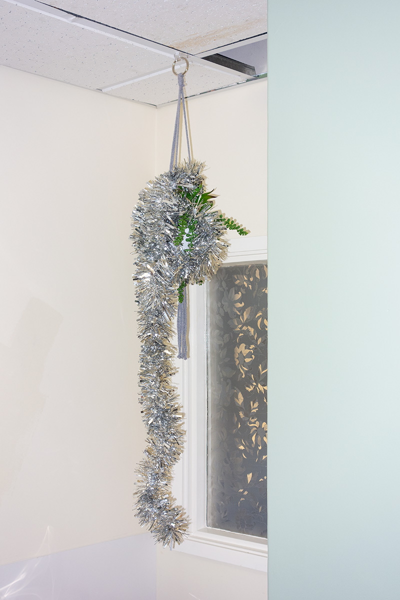 Tinsel hanging from an artificial hanging plant in the kitchen of the Medical Photography department at Cheltenham General Hospital