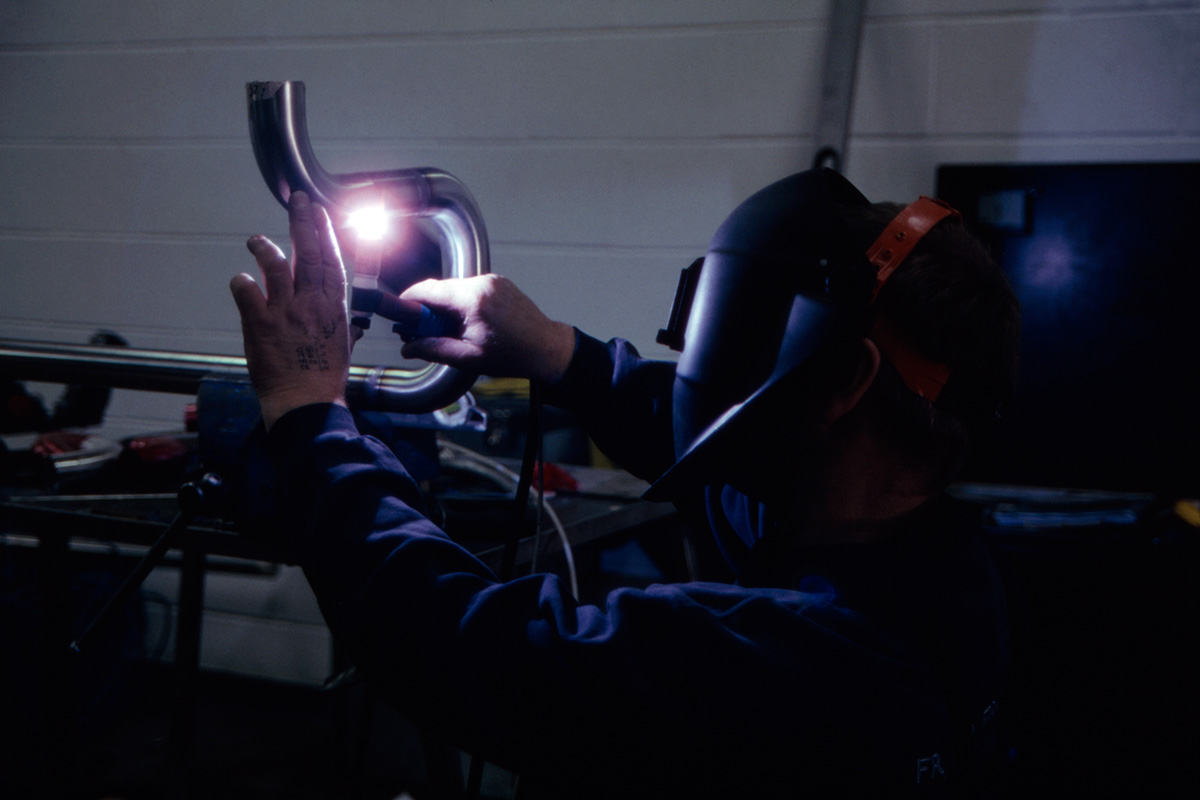 A welder connecting pipes at Moorhouse's new brewery