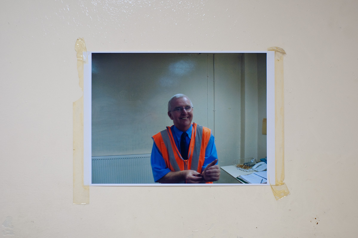 A photograph of a member of staff, taped to a wall