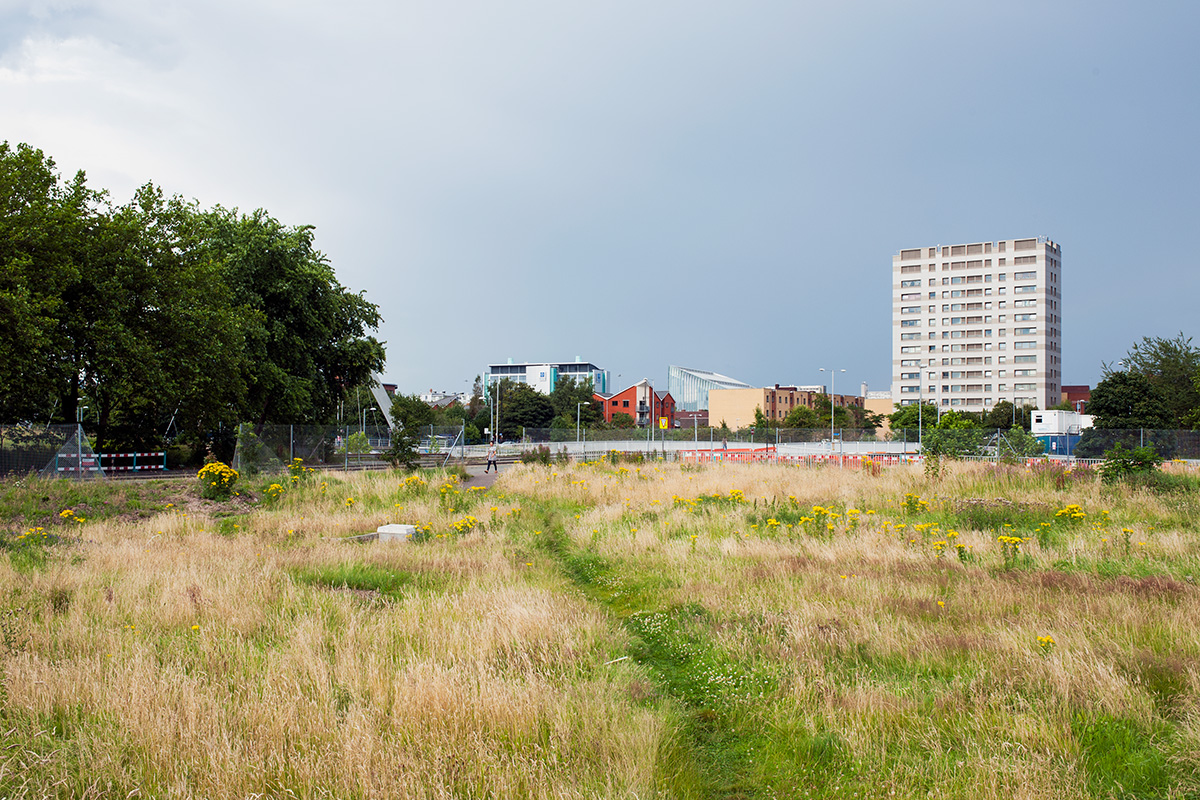 A desire path across the corner of undeveloped land, Hulme, Manchester