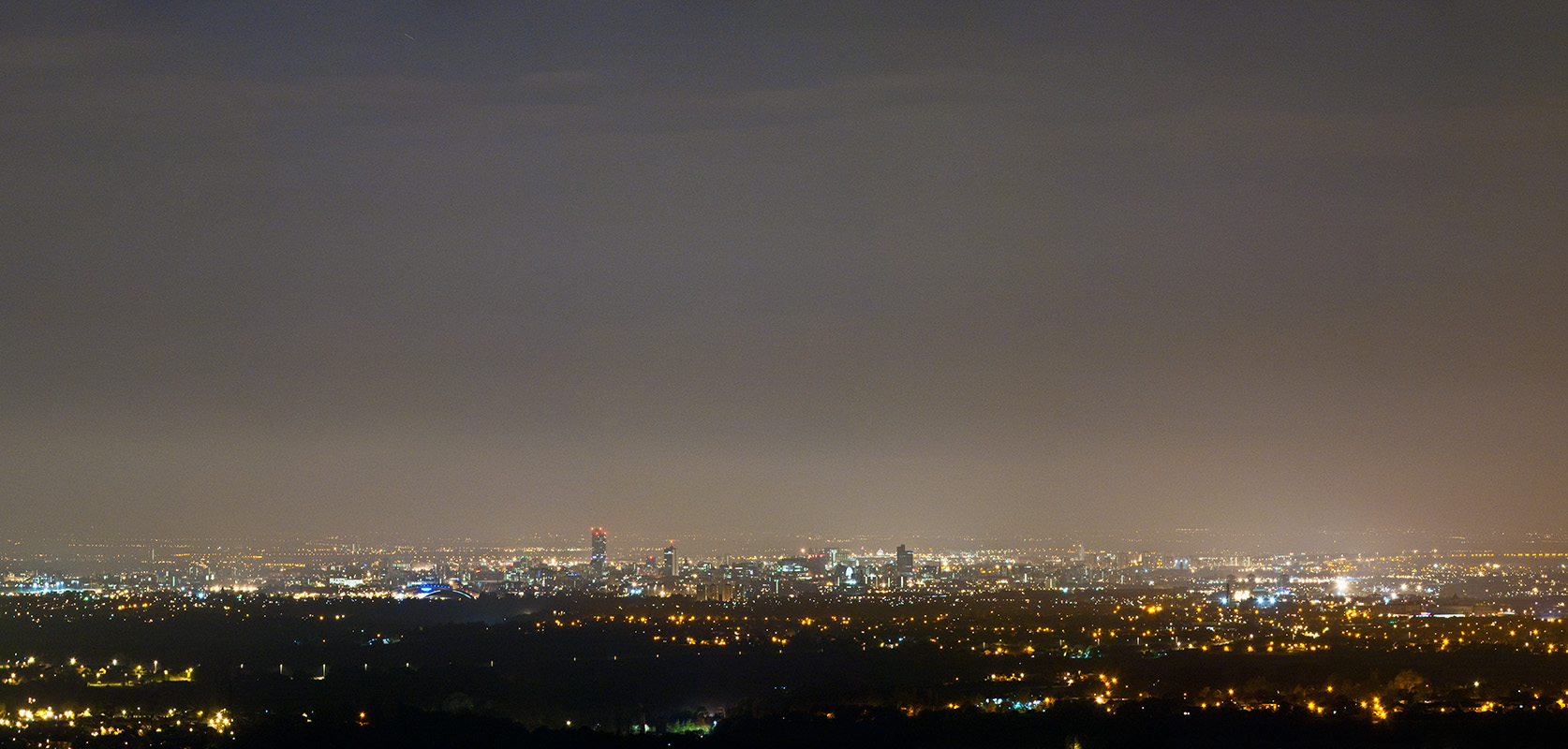A panorama of Manchester from Hartshead Pike at night