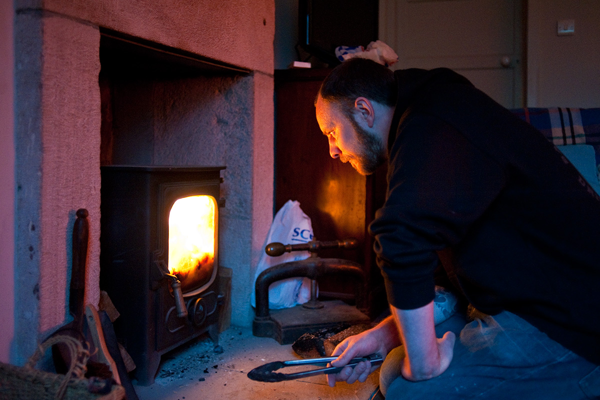 Colin Stronge lighting a fire