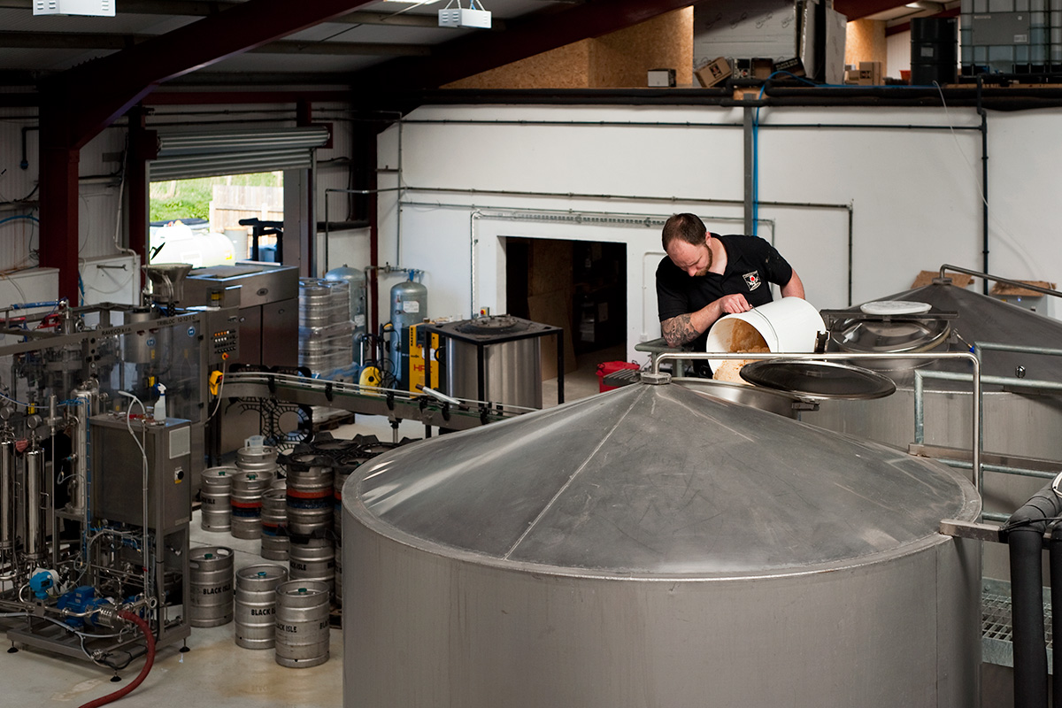 Colin Stronge pitching yeast into a fermenting vessel at Black Isle Brewery