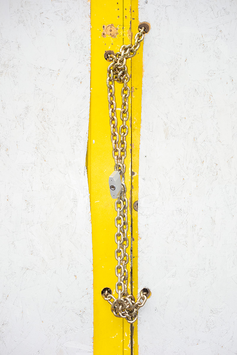 A premises on Kensington High Street with a boarded yellow door locked with a gold chain. Google streetview shows the building was last occupied in 2016 by Snappy Snaps, photo an digital specialists.