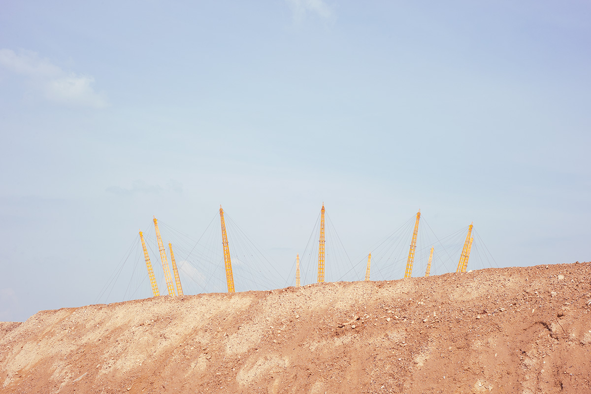 The support struts of the O2 Arena above a pile of soil at the Greenwich development area