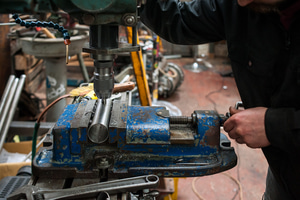 Ted James drilling holes in a headtube to allow the passage of gas during back-filled tig welding