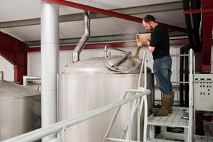 Colin Stronge adding hop pellets to the copper at Black Isle Brewery