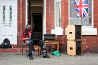 A man DJing at a Jubilee street party in Rusholme, Manchester