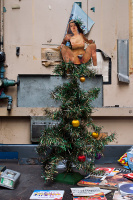 A Christmas tree, with nude woman in place of an angel
