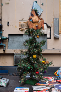 A Christmas tree, with nude woman in place of an angel