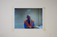 A photograph of a member of staff, taped to a wall