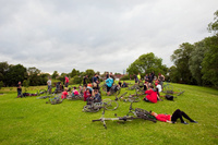 Cyclists gather in Platt Fields Park after a monthly Critical Mass ride