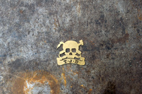 Ted James Design headbadge on a workbench