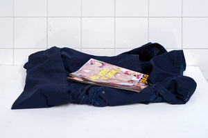 A pornographic magazine left atop a folded jacket