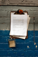 An altered redundancy letter attached to a clipboard, with personal effects
